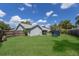 Lush backyard featuring a trampoline and ample green space, ideal for outdoor activities at 613 E 49Th E St, Bradenton, FL 34208