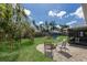 Spacious backyard with lush grass, a playset, and patio area, perfect for outdoor enjoyment at 613 E 49Th E St, Bradenton, FL 34208