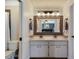 Well-lit bathroom with double sinks, marble countertops, and a large mirror at 613 E 49Th E St, Bradenton, FL 34208