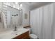 Cozy bathroom with a wood vanity, decorative mirror, and shower-tub combination at 613 E 49Th E St, Bradenton, FL 34208