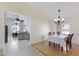 Bright dining room features wood floors, chandelier lighting, and a large window with plantation shutters at 613 E 49Th E St, Bradenton, FL 34208