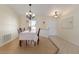 Bright dining room features wood floors, chandelier lighting, and a large window with plantation shutters at 613 E 49Th E St, Bradenton, FL 34208