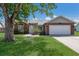 Charming single-story brick home featuring a well-manicured lawn and mature shade tree with a swing at 613 E 49Th E St, Bradenton, FL 34208