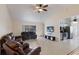Spacious living room with tile flooring, comfortable seating, and an open view of the kitchen at 613 E 49Th E St, Bradenton, FL 34208