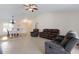 Spacious living room with tile floors, neutral paint, and comfortable seating, adjacent to the dining room at 613 E 49Th E St, Bradenton, FL 34208
