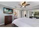 Comfortable main bedroom featuring an ensuite bathroom and access to a screened lanai at 613 E 49Th E St, Bradenton, FL 34208