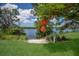 A serene river view framed by lush greenery and vibrant flowering trees at 613 E 49Th E St, Bradenton, FL 34208