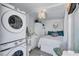 Small room with a stacked washer and dryer, a bed, and a small bathroom at 643 Calle Del Otono, Sarasota, FL 34242