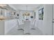 Charming dining area with white table and chairs, seamlessly connected to the kitchen for easy entertaining at 643 Calle Del Otono, Sarasota, FL 34242