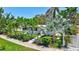 Landscaped home with mature trees and a well manicured lawn at 643 Calle Del Otono, Sarasota, FL 34242