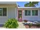 Inviting front entrance with a pink door, a decorative wreath, and lush ferns adding a touch of charm at 643 Calle Del Otono, Sarasota, FL 34242