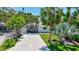 Quaint home surrounded by lush tropical foliage, showcasing a well-maintained lawn and inviting entrance at 643 Calle Del Otono, Sarasota, FL 34242
