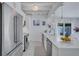 Bright kitchen with white cabinetry, stainless steel appliances, and a view to the backyard at 643 Calle Del Otono, Sarasota, FL 34242
