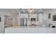 Modern kitchen with white cabinets, stainless steel appliances, and stylish pendant lighting at 643 Calle Del Otono, Sarasota, FL 34242