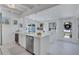 Well-lit kitchen with white island, stainless steel appliances, and access to the dining area at 643 Calle Del Otono, Sarasota, FL 34242