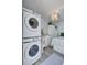 Stacked Samsung washer and dryer in a small room with a bed and a small bathroom at 643 Calle Del Otono, Sarasota, FL 34242
