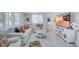 Bright living room with white furniture, decorative pillows, and light herringbone floors at 643 Calle Del Otono, Sarasota, FL 34242