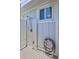 Outdoor shower on a light-colored shiplap wall with white trim and metal grid flooring at 643 Calle Del Otono, Sarasota, FL 34242