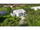 Beautiful aerial view capturing this lakeside home and its surrounding green landscape and mature trees at 6572 Fairway Gardens Dr # 6572, Bradenton, FL 34203