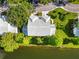 Beautiful condo with serene pond view, lush greenery, and white tile roof at 6572 Fairway Gardens Dr # 6572, Bradenton, FL 34203