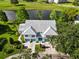 Exceptional aerial view highlighting the property's serene location near a lake and golf course, surrounded by mature trees at 6572 Fairway Gardens Dr # 6572, Bradenton, FL 34203
