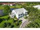 Expansive aerial view showcasing the property's location on a lake, adjacent to a golf course with mature tree cover at 6572 Fairway Gardens Dr # 6572, Bradenton, FL 34203