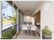 Balcony features a table, chairs, seating area, and views of the lake at 6572 Fairway Gardens Dr # 6572, Bradenton, FL 34203