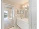 Bright bathroom features a toilet, double vanity, and a glass enclosed shower at 6572 Fairway Gardens Dr # 6572, Bradenton, FL 34203