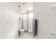 Bright bathroom featuring a toilet, glass enclosed shower, vanity, and wallpaper at 6572 Fairway Gardens Dr # 6572, Bradenton, FL 34203