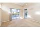 Neutral bedroom with a ceiling fan and sliding glass doors with balcony overlooking pond at 6572 Fairway Gardens Dr # 6572, Bradenton, FL 34203
