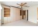 Bedroom features a ceiling fan, built-in closet and shelving, with mirrored closet doors at 6572 Fairway Gardens Dr # 6572, Bradenton, FL 34203