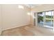 Neutral bedroom with a ceiling fan and sliding glass doors with balcony overlooking pond at 6572 Fairway Gardens Dr # 6572, Bradenton, FL 34203