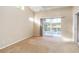 Neutral bedroom with a ceiling fan, two windows, and sliding glass doors overlooking golf course at 6572 Fairway Gardens Dr # 6572, Bradenton, FL 34203