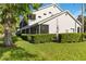 Lush landscaping surrounds the exterior of this home with a screened patio, offering privacy and scenic views at 6572 Fairway Gardens Dr # 6572, Bradenton, FL 34203