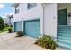 Close-up of the two-story condo showcasing the attached garage and front door at 6572 Fairway Gardens Dr # 6572, Bradenton, FL 34203