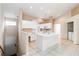 Bright kitchen featuring white cabinetry, tiled floors and an island at 6572 Fairway Gardens Dr # 6572, Bradenton, FL 34203