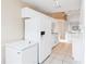 White kitchen featuring tiled floor and white appliances at 6572 Fairway Gardens Dr # 6572, Bradenton, FL 34203