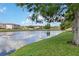 Picturesque lake view surrounded by lush greenery and mirrored by clear blue skies, creating a tranquil setting at 6572 Fairway Gardens Dr # 6572, Bradenton, FL 34203