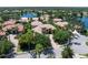 Aerial view of tile roof home showcasing lush landscaping and waterfront neighborhood at 6808 Belmont Ct, Lakewood Ranch, FL 34202