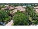 Aerial view of tile roof home showcasing lush landscaping with lake view at 6808 Belmont Ct, Lakewood Ranch, FL 34202