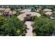 Aerial view of tile roof home showcasing lush landscaping with lake view at 6808 Belmont Ct, Lakewood Ranch, FL 34202
