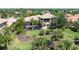 Beautiful backyard featuring lush landscaping, palm trees, a private pool, and a screened-in lanai at 6808 Belmont Ct, Lakewood Ranch, FL 34202