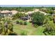 Lush backyard with mature trees, landscaped grounds, and a screened-in pool enhancing the outdoor space at 6808 Belmont Ct, Lakewood Ranch, FL 34202