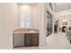 A stylish bar area features a mini-fridge, marble countertop, and seamless transition to other rooms at 6808 Belmont Ct, Lakewood Ranch, FL 34202