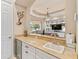 Bar with granite counters, wine fridge, and sink leading to the living room and lanai at 6808 Belmont Ct, Lakewood Ranch, FL 34202
