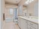 Bright bathroom with white cabinets, a long countertop, and a bathtub with shower at 6808 Belmont Ct, Lakewood Ranch, FL 34202