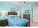 Bedroom with light blue walls, dark furniture, and a comfortable bed with floral patterned bedding at 6808 Belmont Ct, Lakewood Ranch, FL 34202