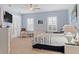 Light-filled bedroom with neutral paint, white furniture, and a ceiling fan with a wicker finish at 6808 Belmont Ct, Lakewood Ranch, FL 34202