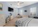 Light-filled bedroom with neutral paint, white furniture, and a ceiling fan with a wicker finish at 6808 Belmont Ct, Lakewood Ranch, FL 34202