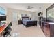 Spacious bedroom features a ceiling fan, two windows with shutters, and a computer desk at 6808 Belmont Ct, Lakewood Ranch, FL 34202